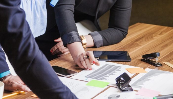 people-leaning-desk-standing